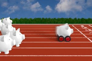 white piggy bank with wheels winning the race
